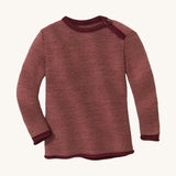 Disana organic merino wool melange jumper in a dark red colour on a cream background.