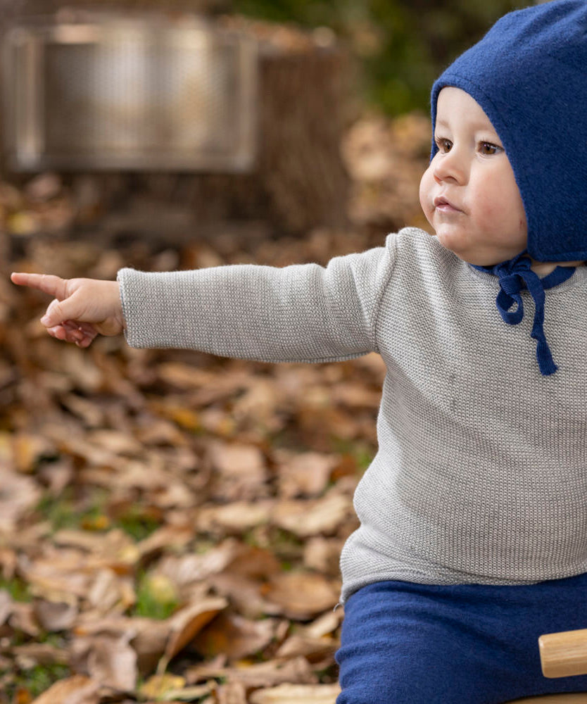 Disana organic merino wool melange jumper in a grey colour worn by a baby 