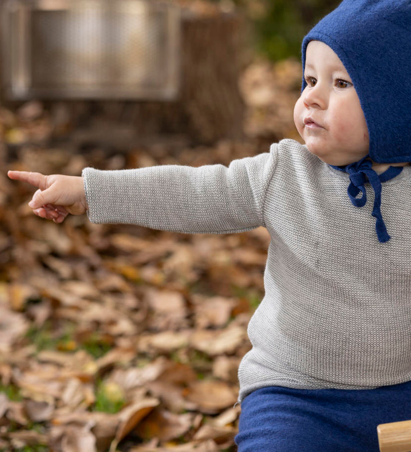 Disana organic merino wool melange jumper in a grey colour worn by a baby 