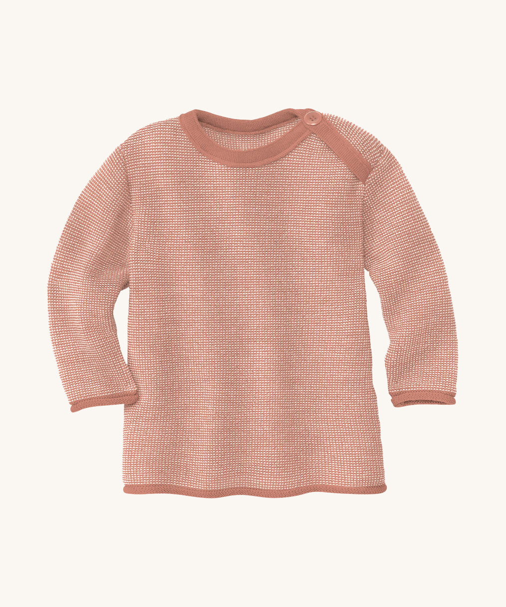 Disana organic merino wool melange jumper in a light pink colour on a cream background.