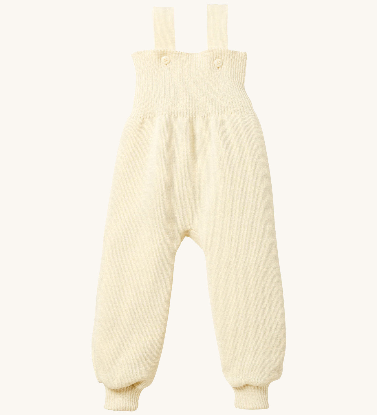 Disana organic merino wool dungarees in natural on a cream background.