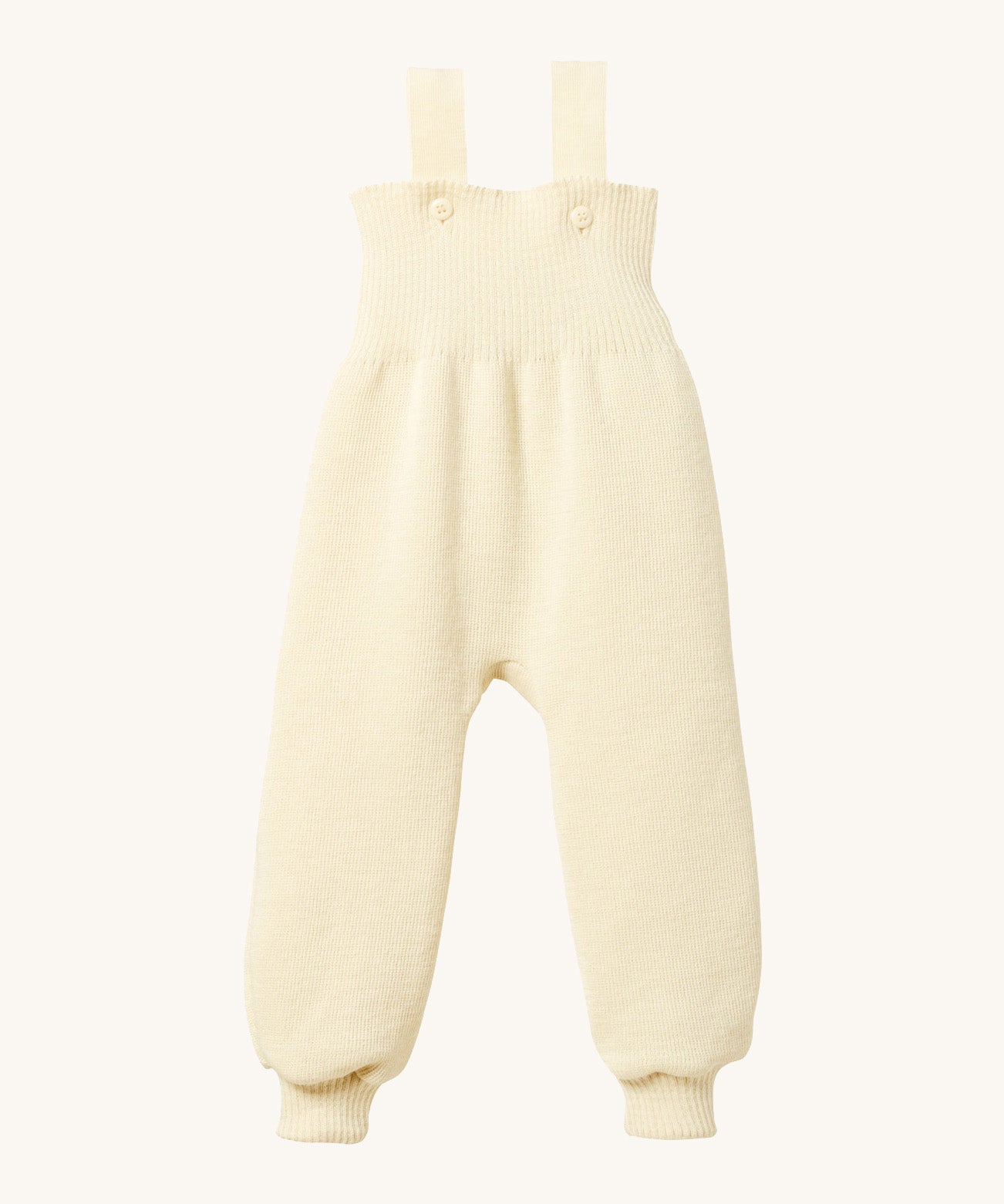 Disana organic merino wool dungarees in natural on a cream background.