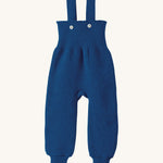 Disana organic merino wool dungarees in navy on a cream background.