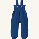 Disana organic merino wool dungarees in navy on a cream background.