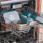 Two Eco Rascals Stainless Steel Lunch Boxes shown with all the pieces separated and placed on the top rack of a dishwasher. 