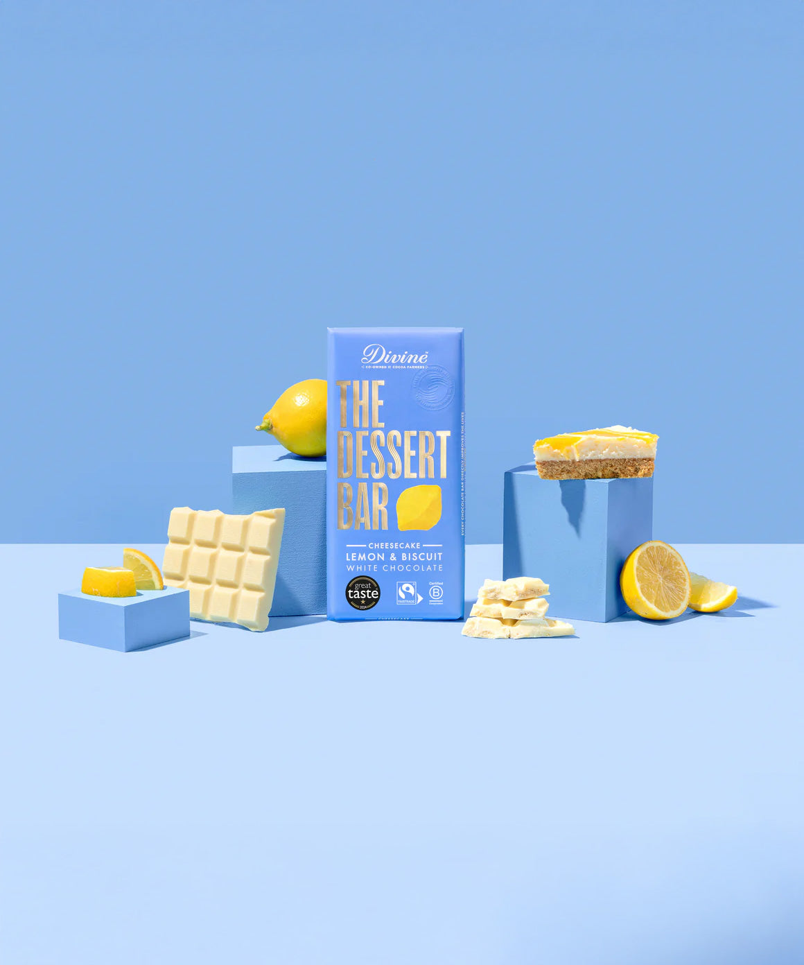 The Divine White Chocolate Lemon Cheesecake Dessert Bar shiwn in it's wrapping with an unwrapped bar by it's side.