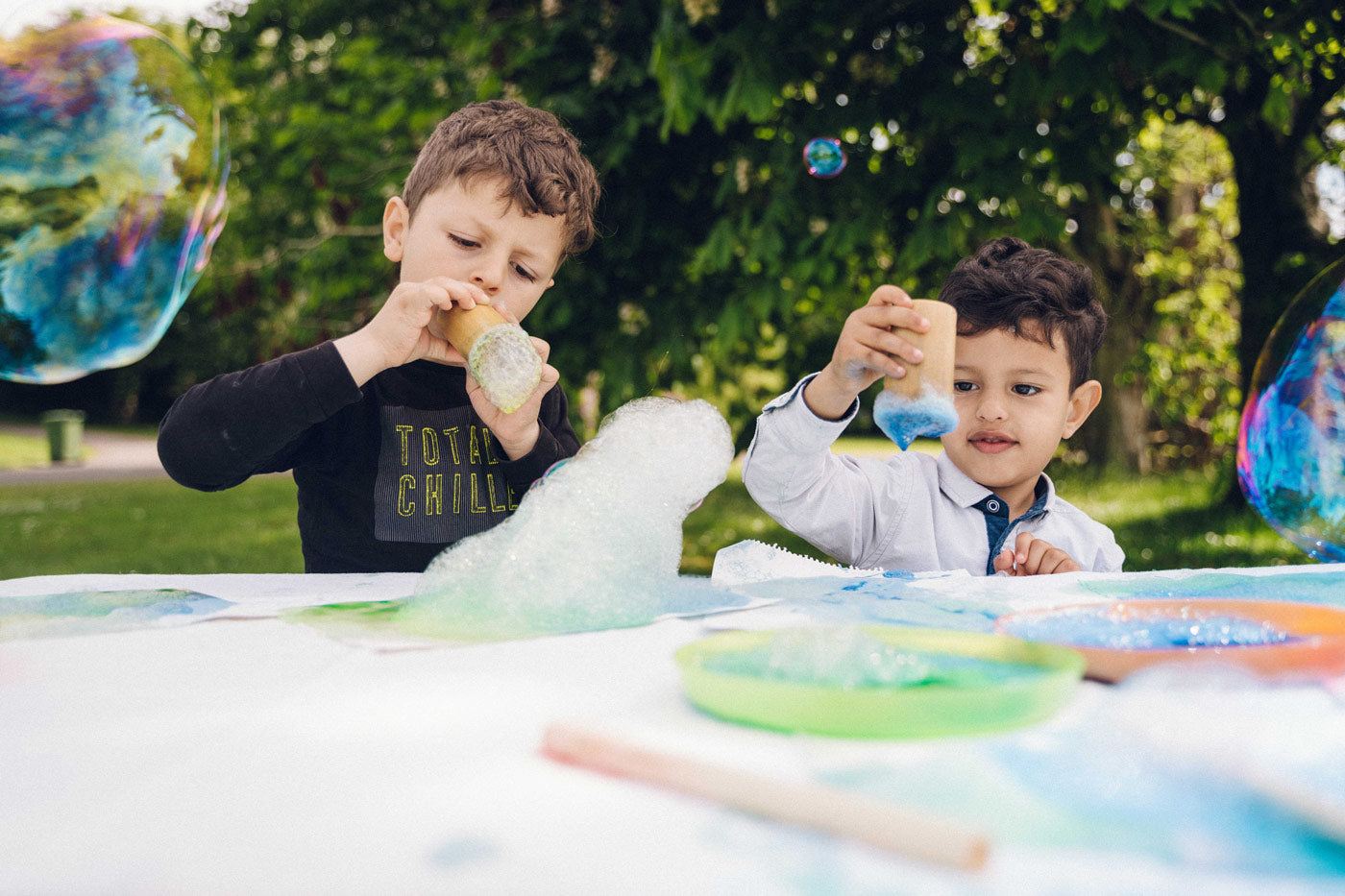 Girl blowing blue bubbles through the Dr Zigs eco-friendly bamboo bubble blowing tube