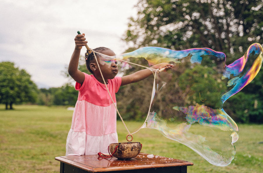 Girl playing outdoors with the Dr Zigs eco-friendly giant bubbles