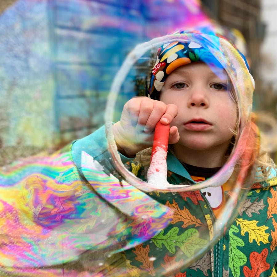 Close up of boys face blowing a giant Dr Zigs bubble