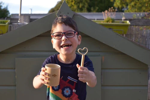 Child holding the small wand shaped like a heart from the mini kit