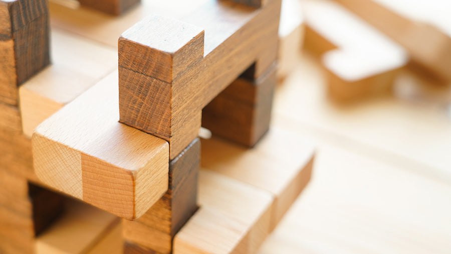 Close up of the Drei Blatter handmade sustainably sourced beech wood Chinter blocks on a wooden background