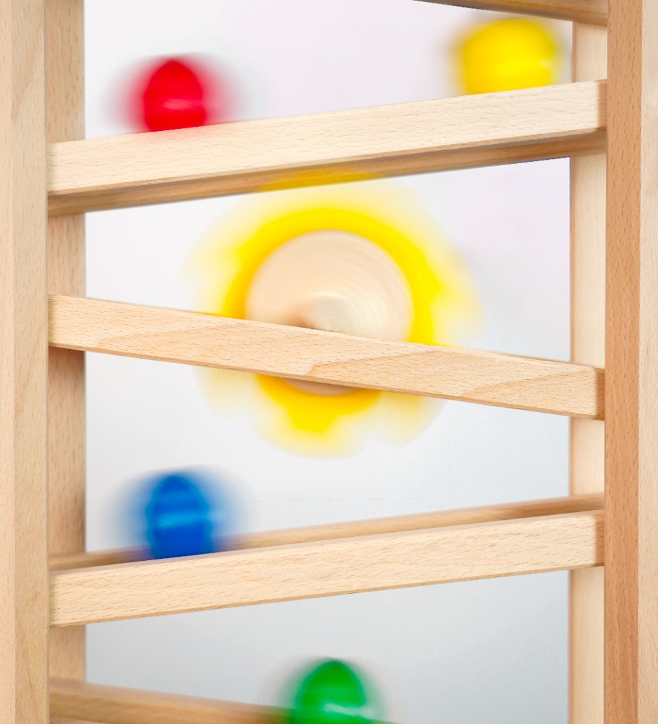 Close up of some Fagus marbles rolling down their handmade wooden marble run set