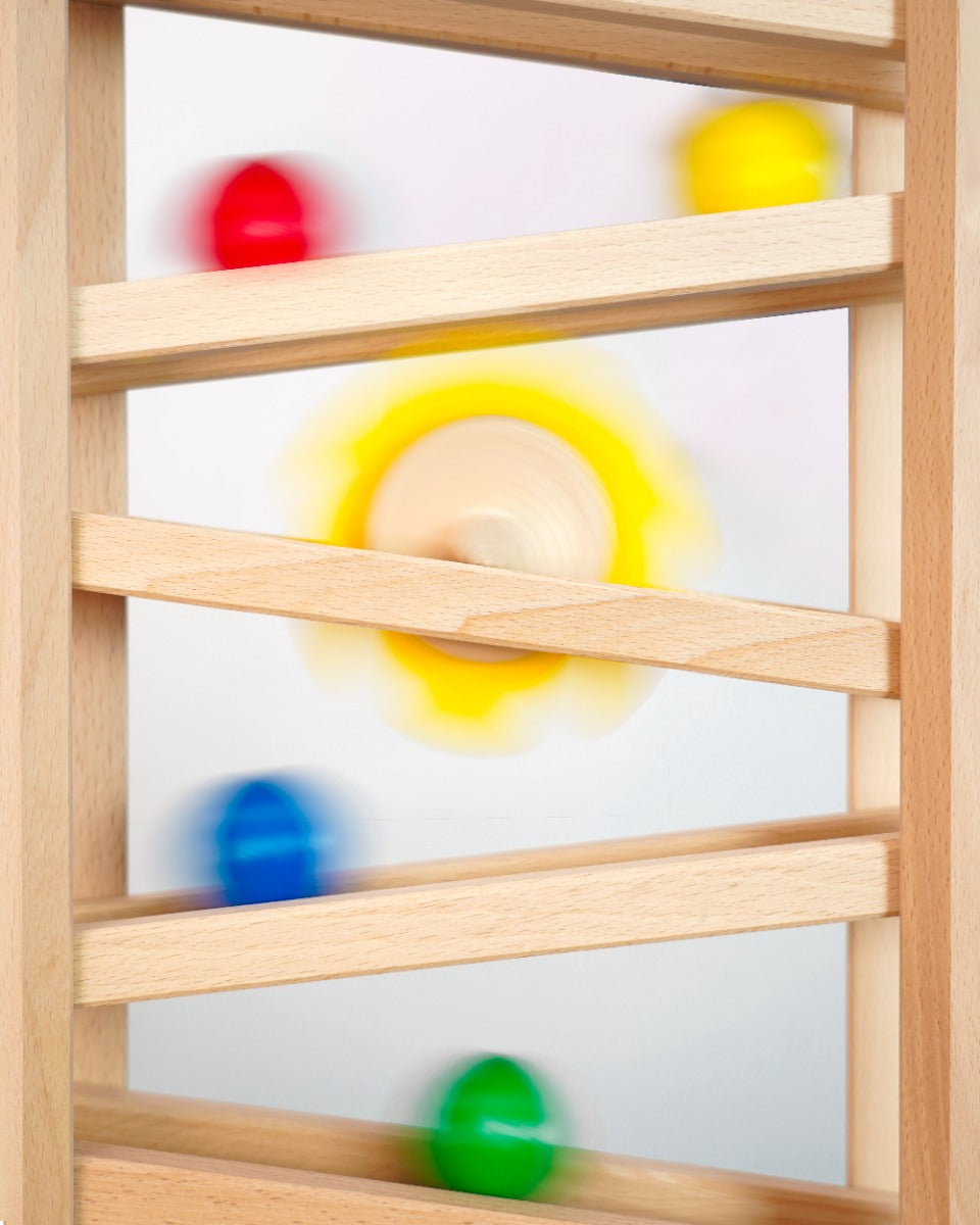 Close up of some Fagus marbles rolling down their handmade wooden marble run set