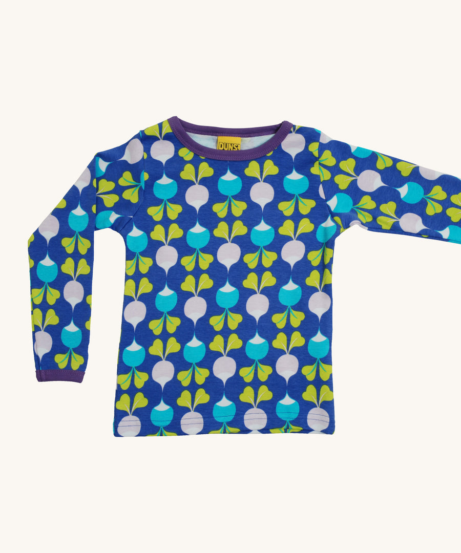 A light blue Duns long sleeve top with a light blue and light purple radish design on a cream background