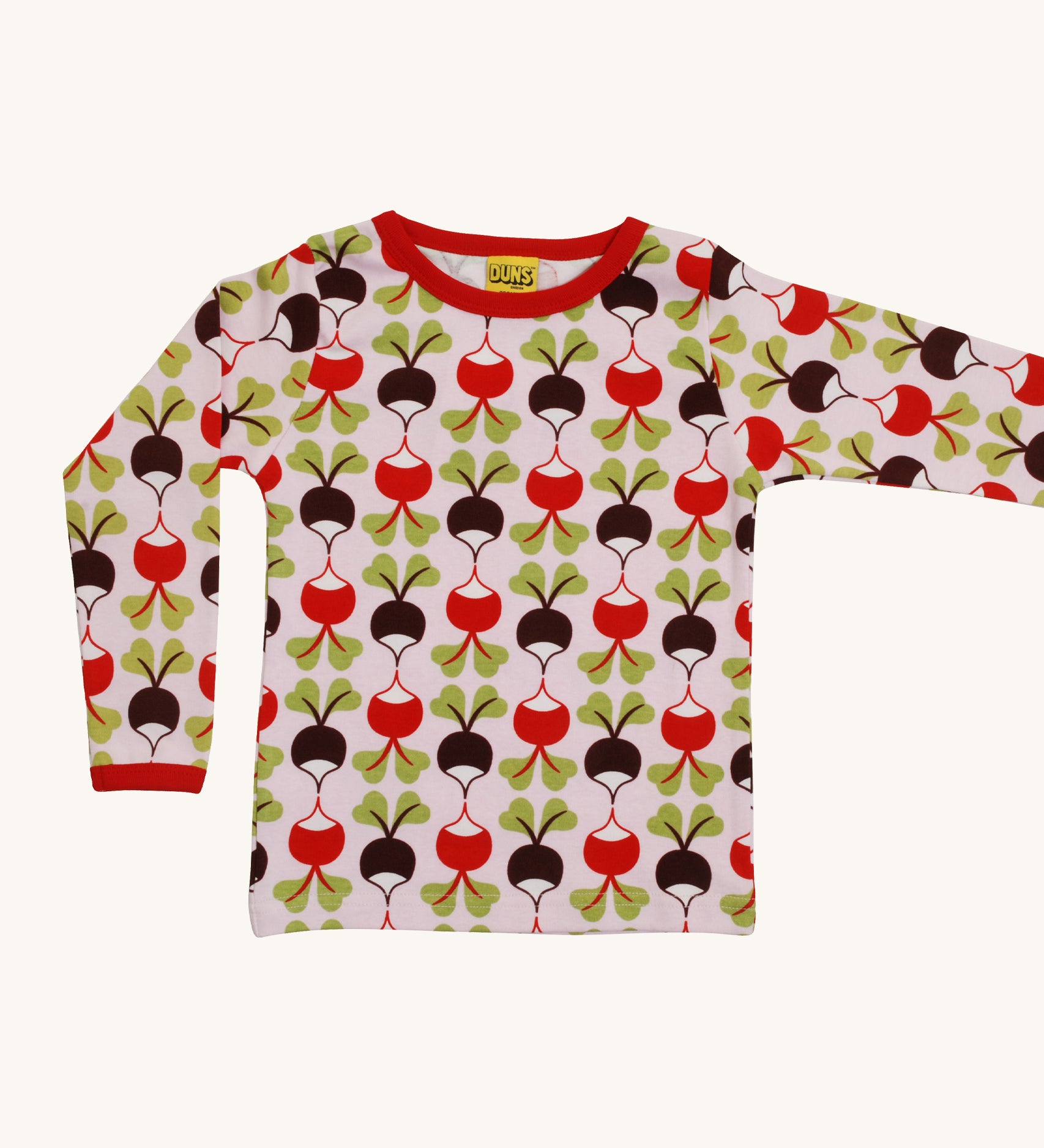 A light pink Duns long sleeve top with a red and brown radish design on a cream background