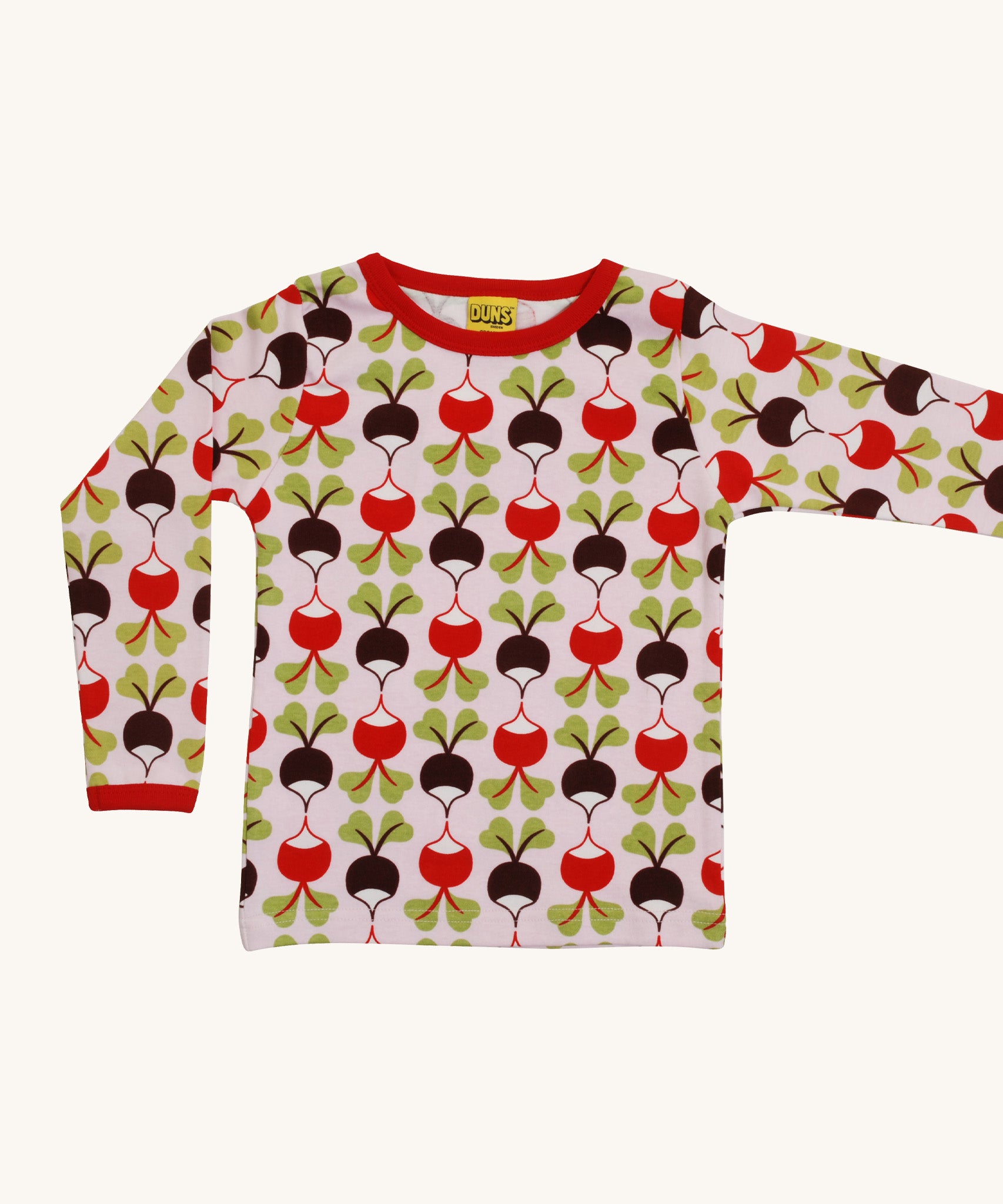 A light pink Duns long sleeve top with a red and brown radish design on a cream background