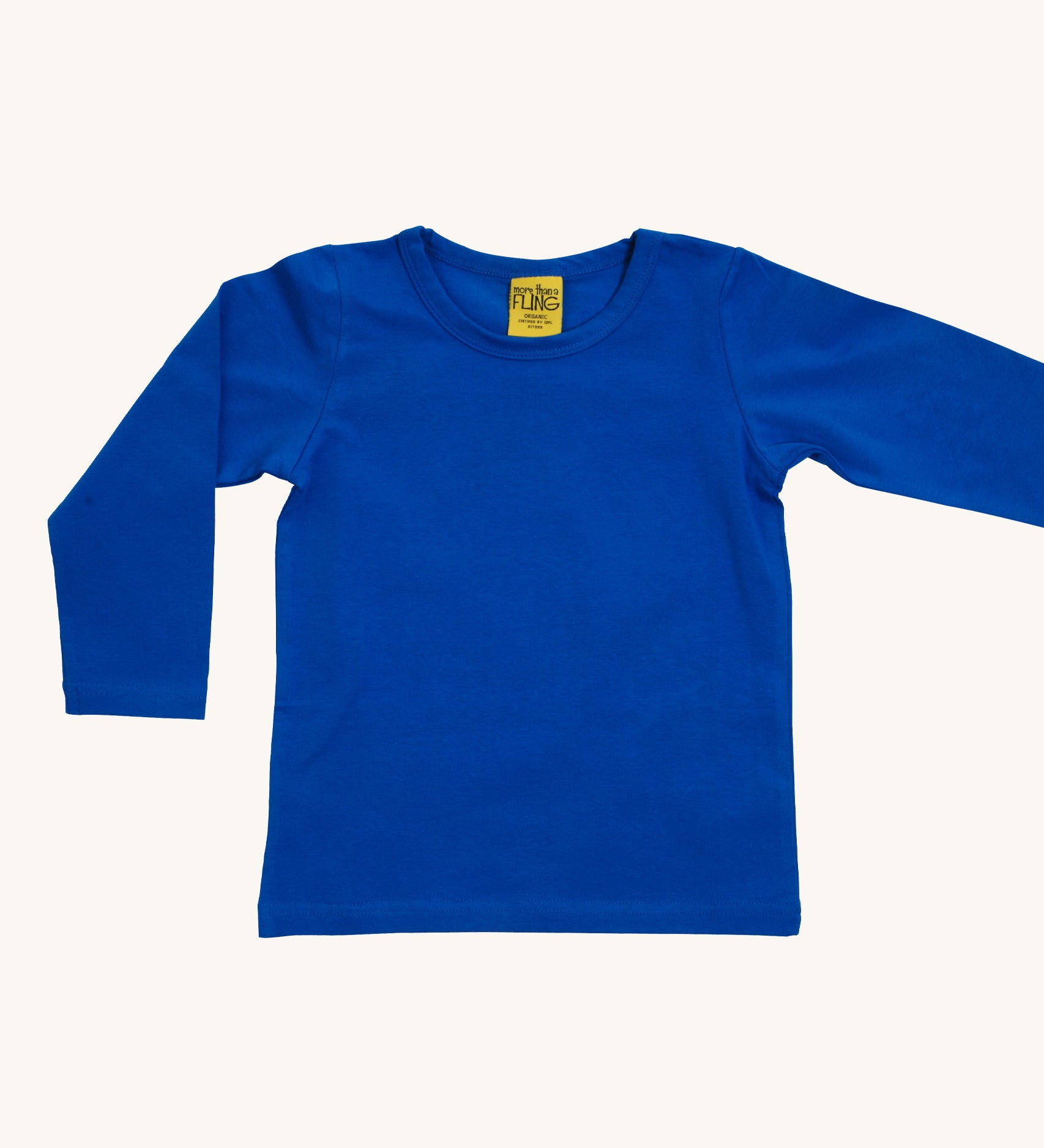 A blue Duns long sleeve top on a cream background.