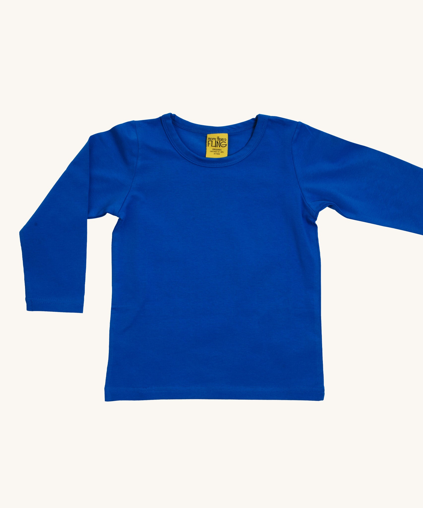 A blue Duns long sleeve top on a cream background.