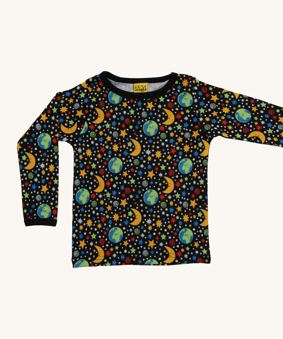 A black Duns long sleeve top with the earth, the moon and stars design on a cream background