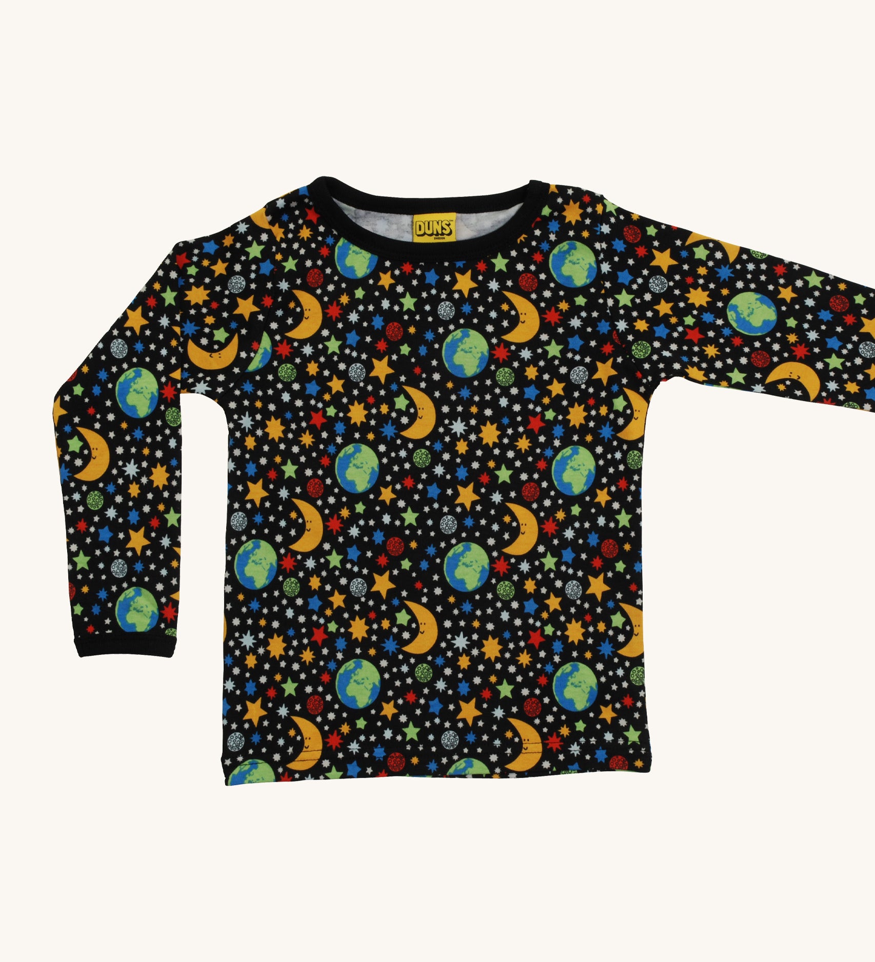 A black Duns long sleeve top with the earth, the moon and stars design on a cream background