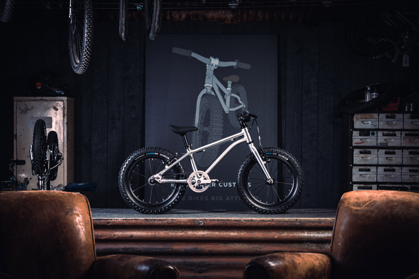 Early Rider children's 16 inch seeker bicycle on a metal work bench in a dark workshop