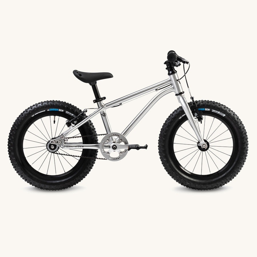 Side of the Early Rider seeker 16 inch aluminium kids bike on a beige background