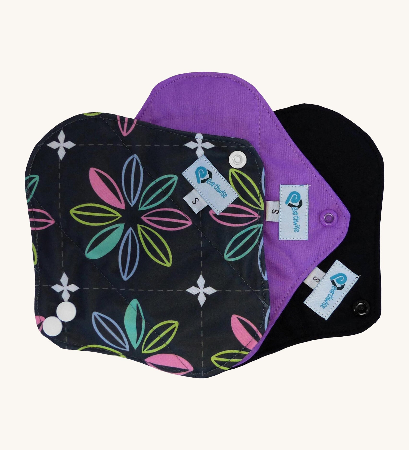 Three Earthwise Panty Liners in charcoal with flowers, purple and black.