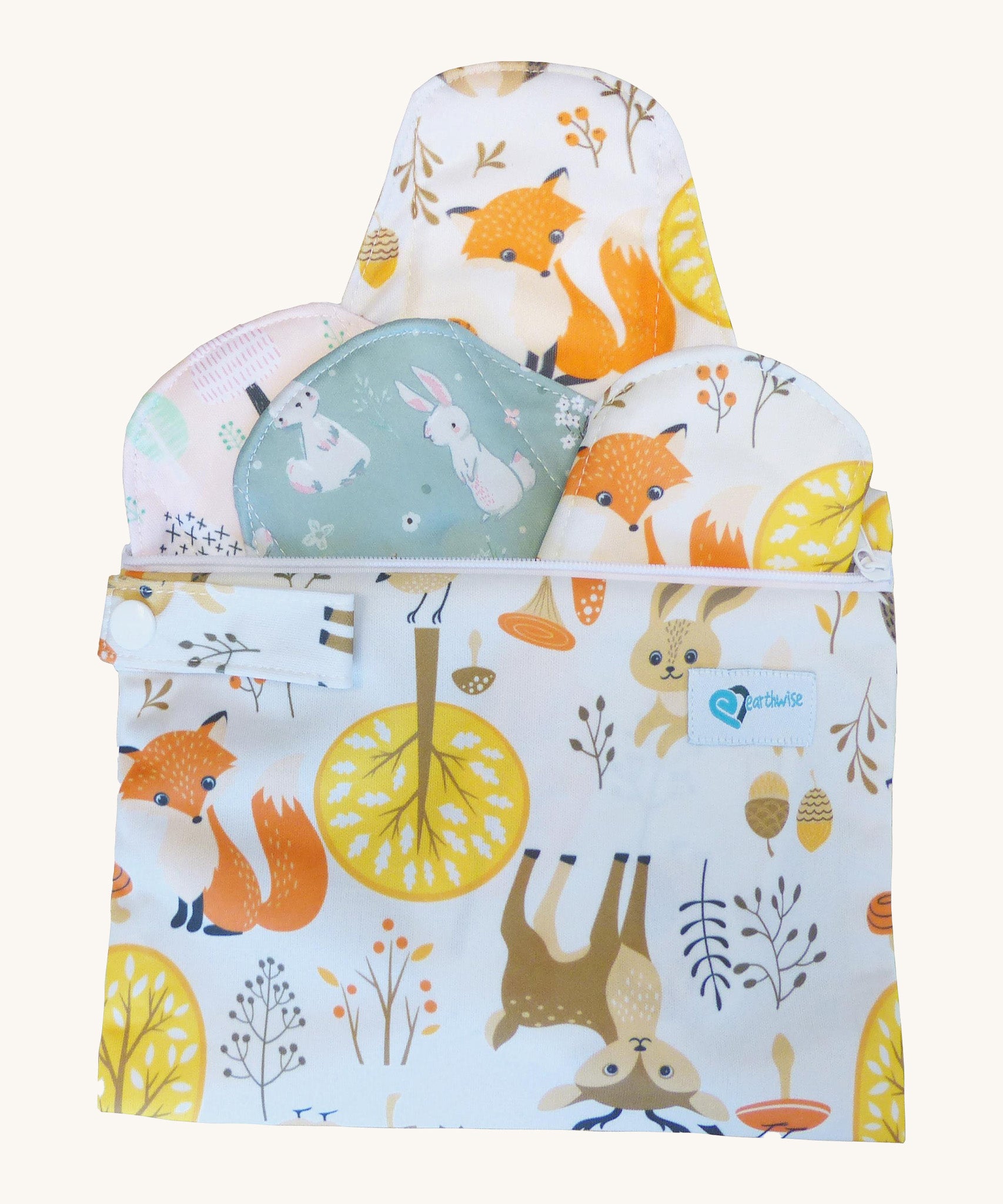 Earthwise starter kit includes 4 reusable period pads and a coordinating mini wet bag purse in Woodland print.