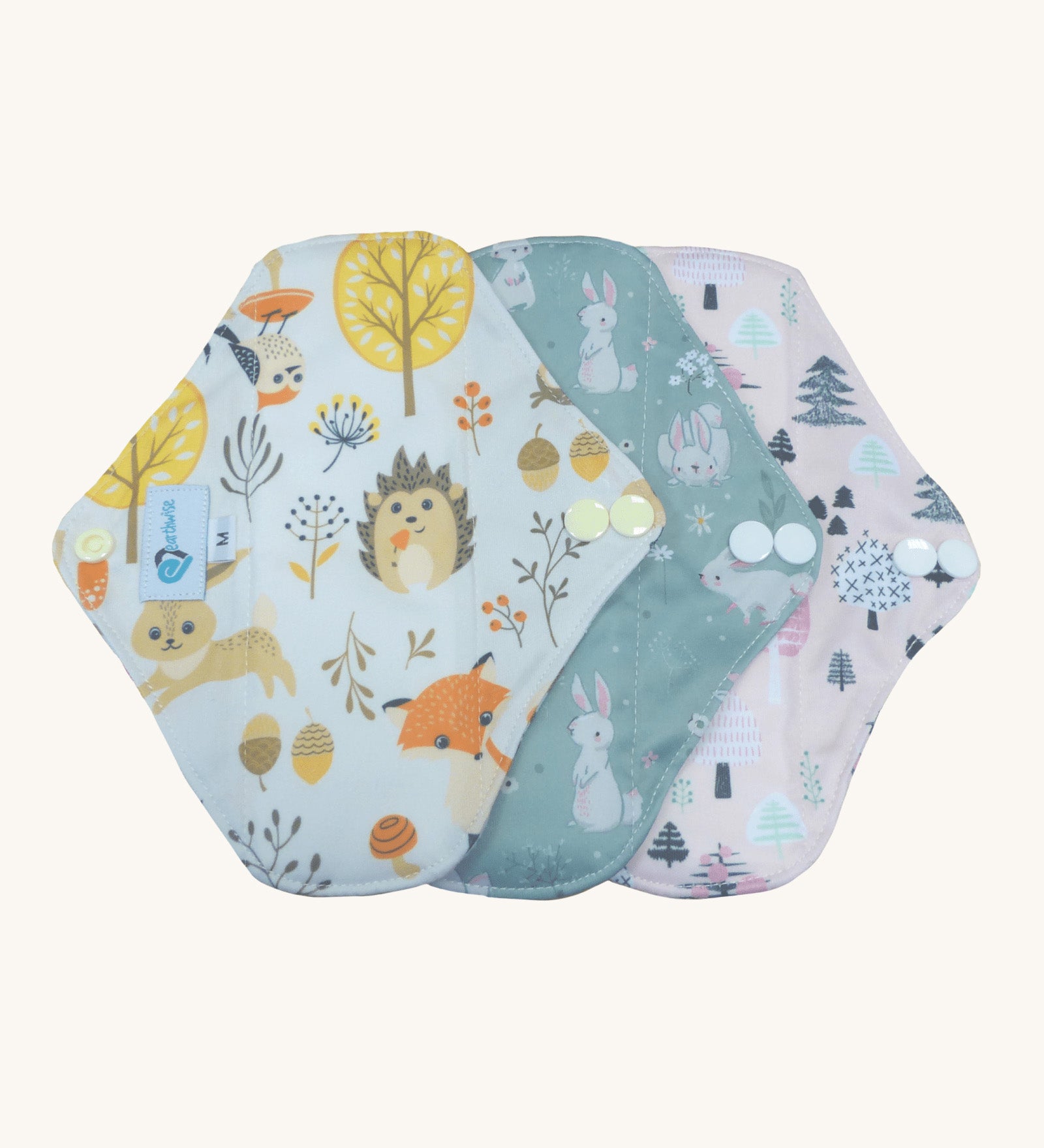 Three Earthwise reusable period pads in cute woodland prints.