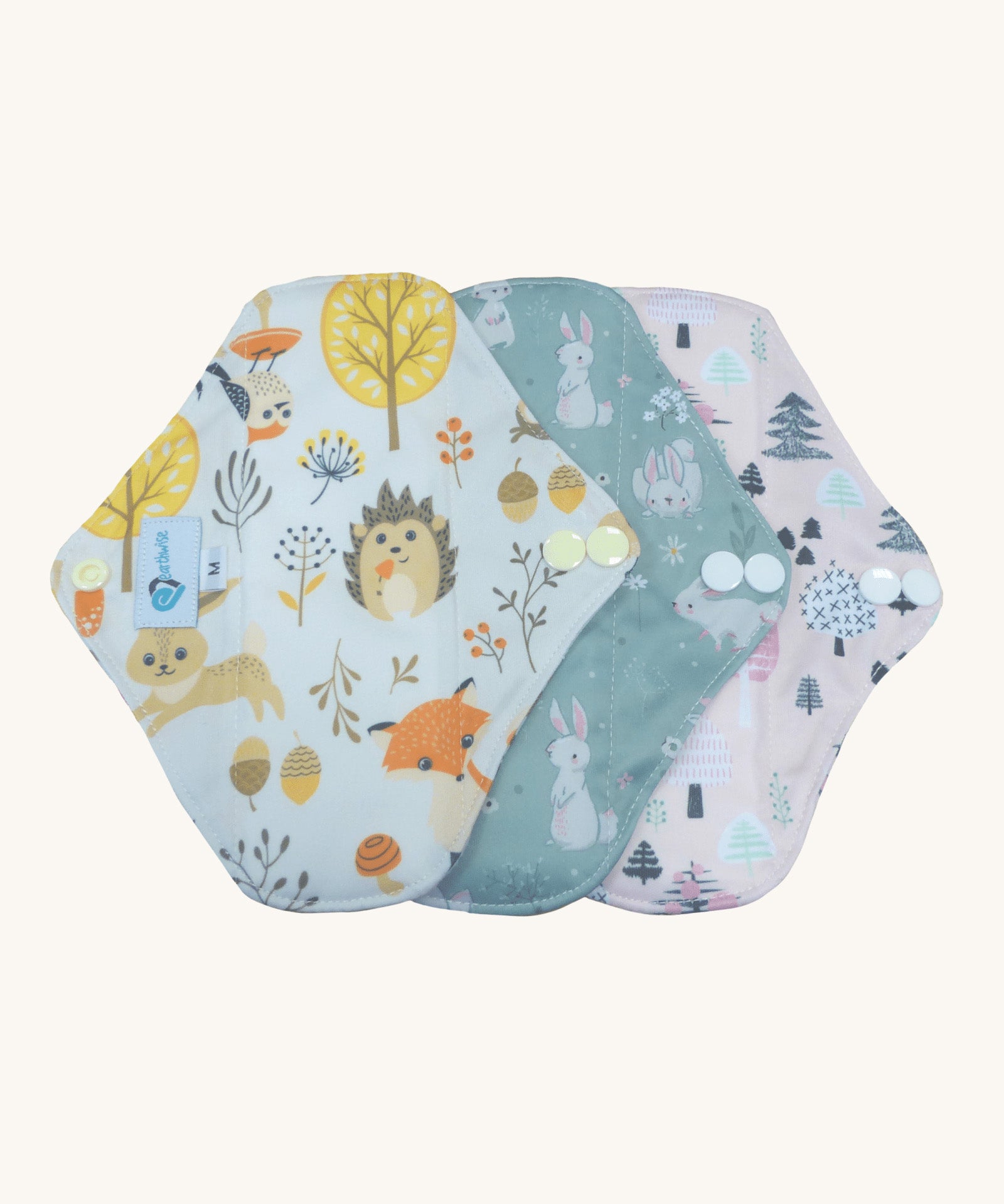 Three Earthwise reusable period pads in cute woodland prints.