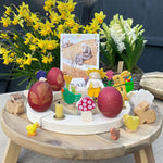 Eggs dyed using teh Okonorm egg dye kit shown on a celebration ring display with Easter and Spring themed toys and decorations. 