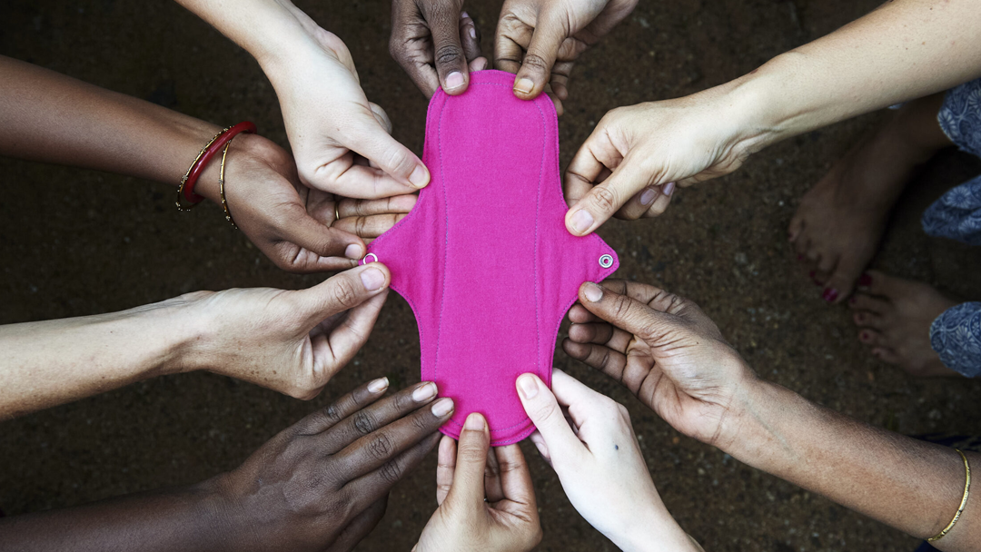 Hands holding up an Eco Femme reusable period pad