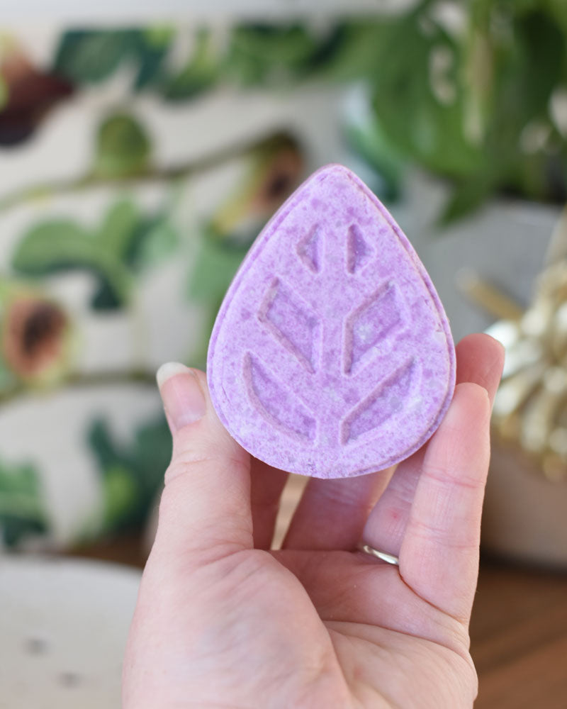 person holding eco living shampoo bar in hand