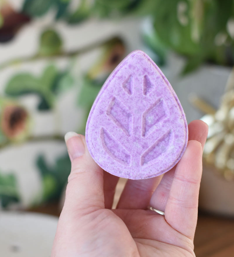 person holding eco living shampoo bar in hand