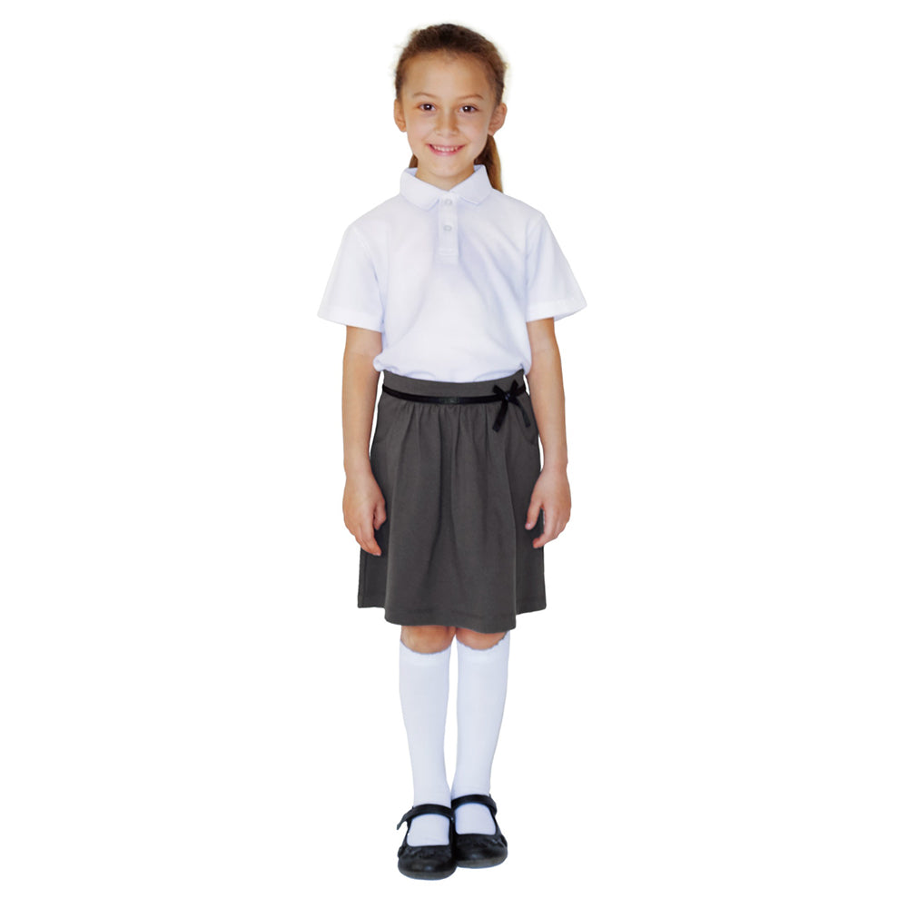 Young girl stood wearing a white top with an Eco Outfitters FairTrade organic cotton Jersey Skirt on a white background