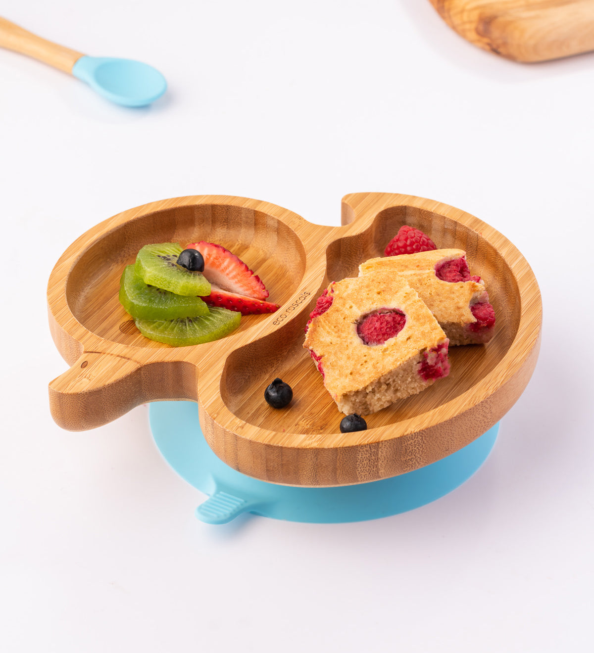 Bamboo duck-shaped weaning plate with fruit and cake.