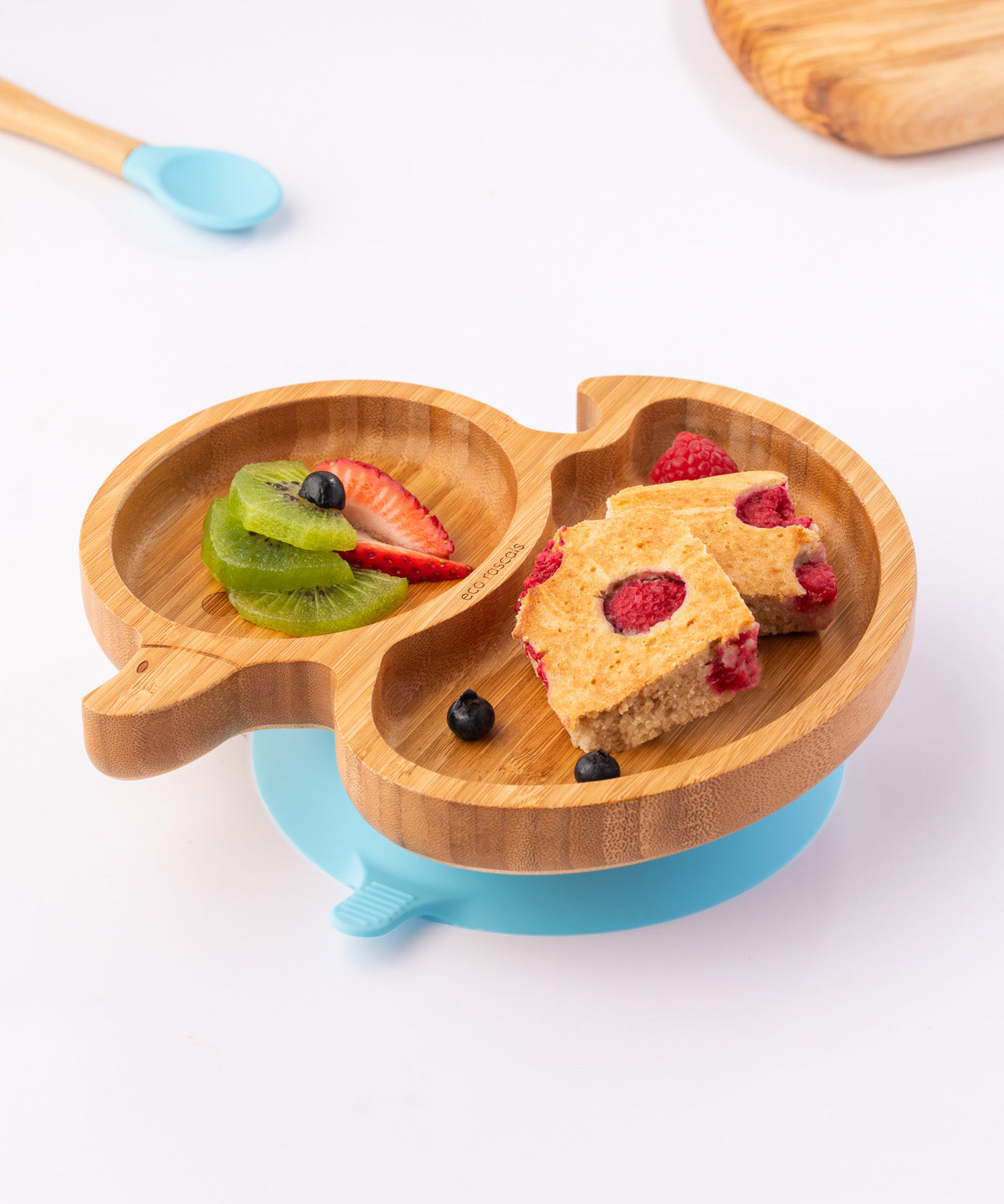 Bamboo duck-shaped weaning plate with fruit and cake.