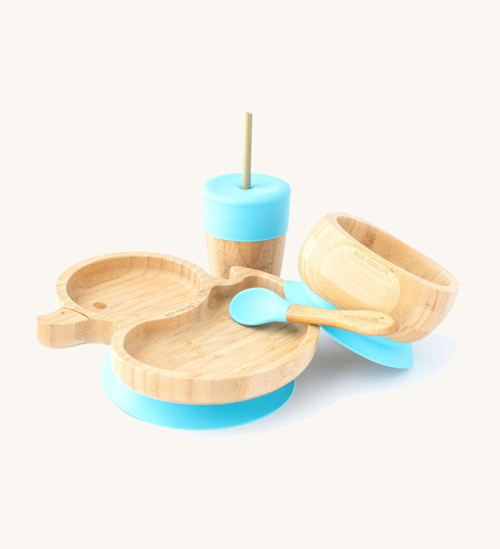 A bamboo baby weaning set by Eco Rascals including a duck-shaped bamboo weaning suction plate, a sippy cup, and a suction bamboo bowl with blue silicone details.