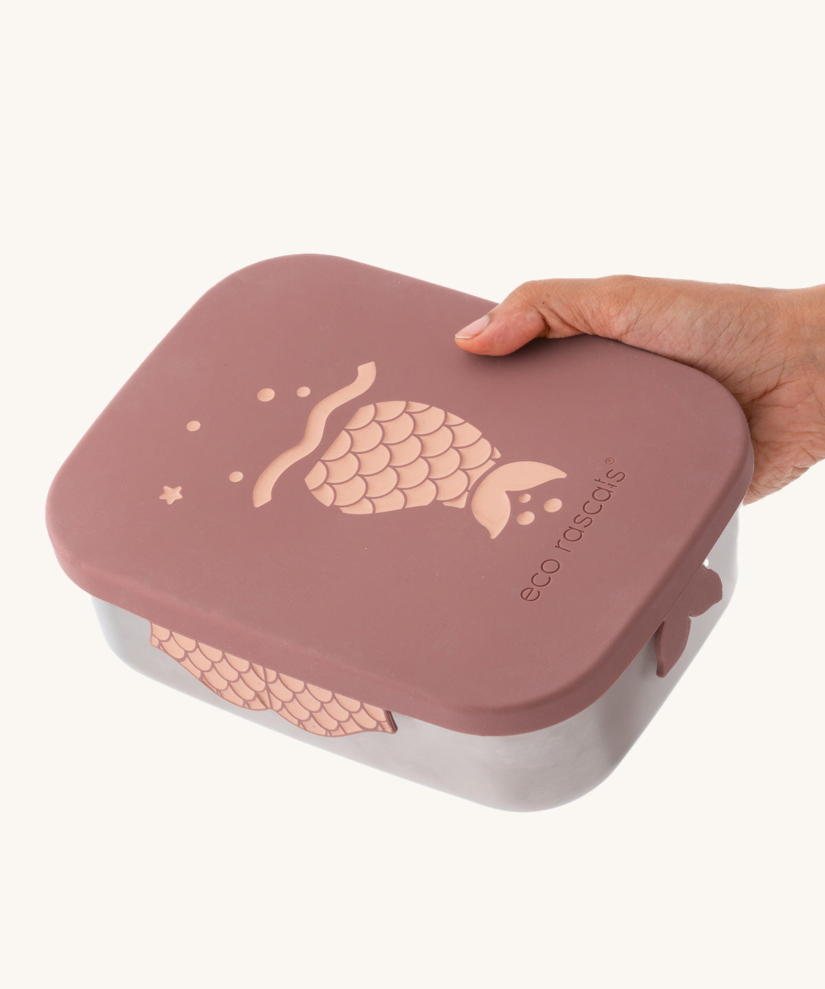 An adult's hand holding on to the rose pink mermaid design The rose pink mermaid design Eco Rascals Stainless Steel Character Lunch Box.