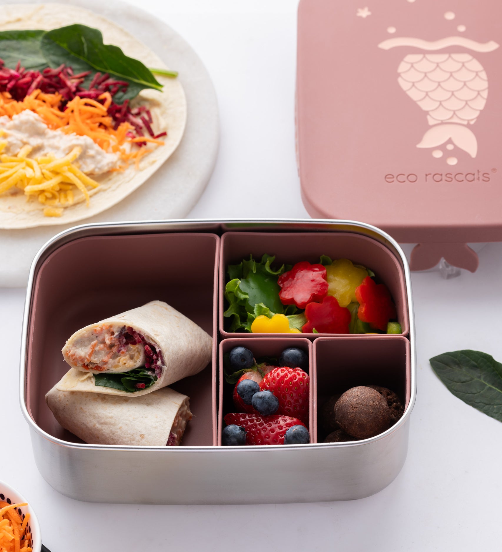 Eco Rascals Stainless Steel rose mermaid Character Lunch Box with food inside. Rainbow wraps in the largest section and fruit and vegetables in the other three smaller sections. 