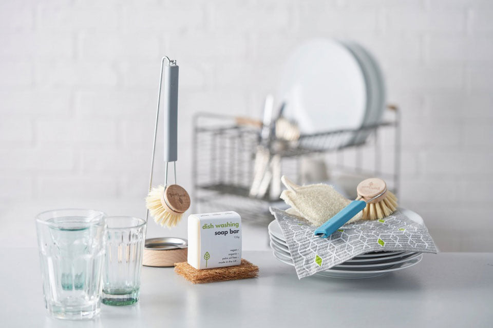 Ecoliving Dish Brush with Replaceable Heads pictured alongside other ecoliving kitchen products in a kitchen