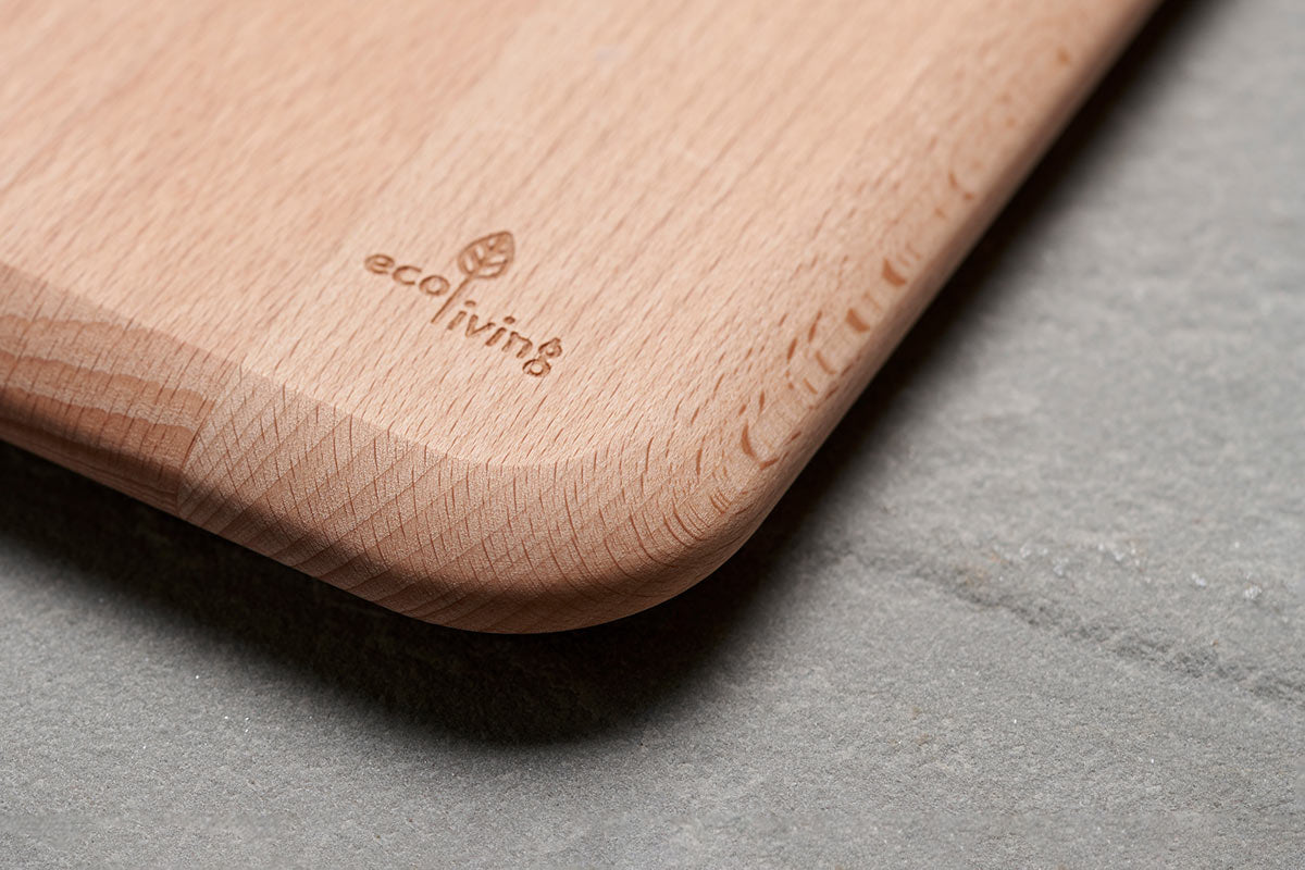 Close up of Ecoliving logo carved into the corner of sustainable Beech wood chopping board