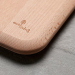 Close up of Ecoliving logo carved into the corner of sustainable Beech wood chopping board