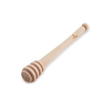 Eco living wooden honey dipper on a white background