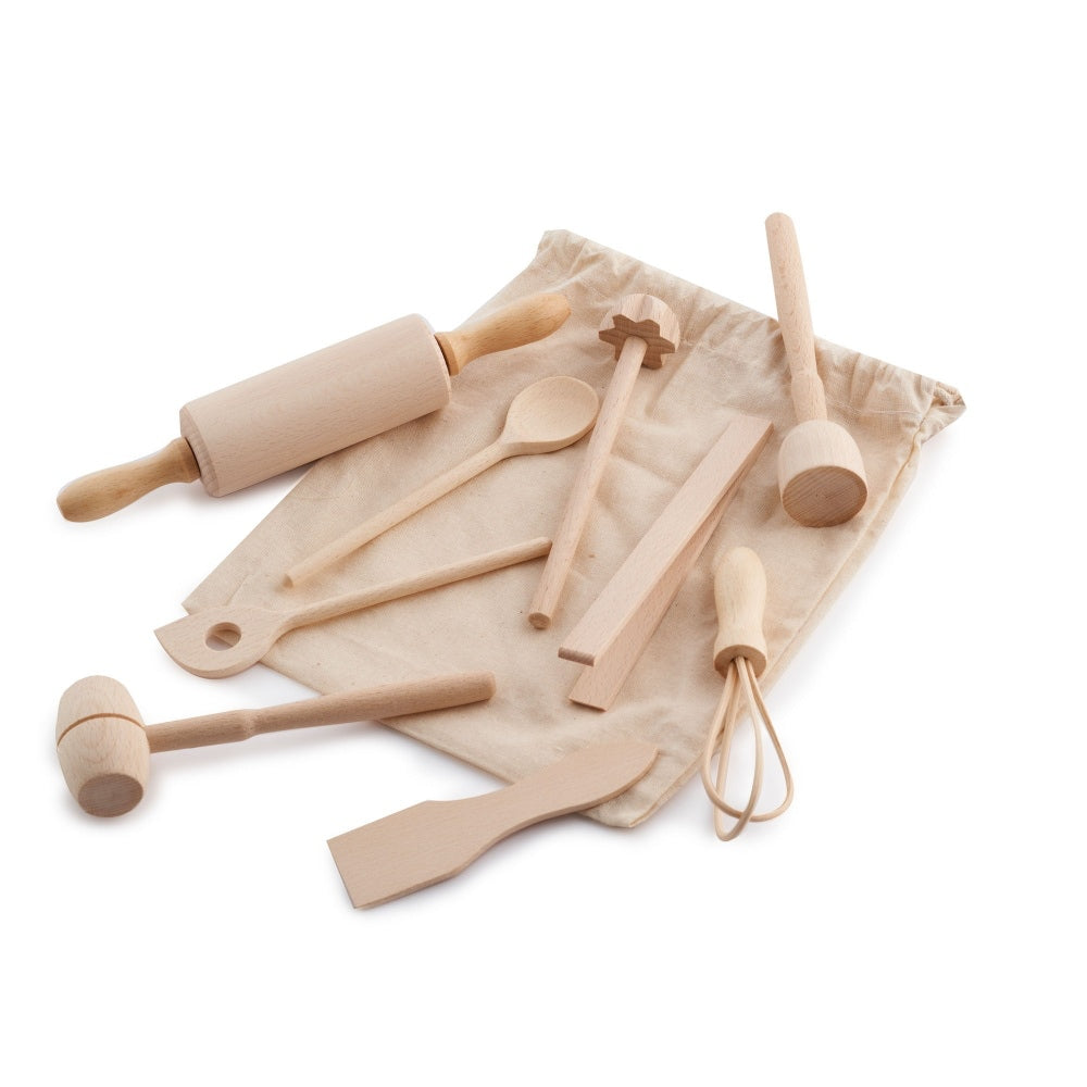 Evolving wooden mini kitchen utensil set laid on and around its natural cotton bag