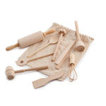 Evolving wooden mini kitchen utensil set laid on and around its natural cotton bag