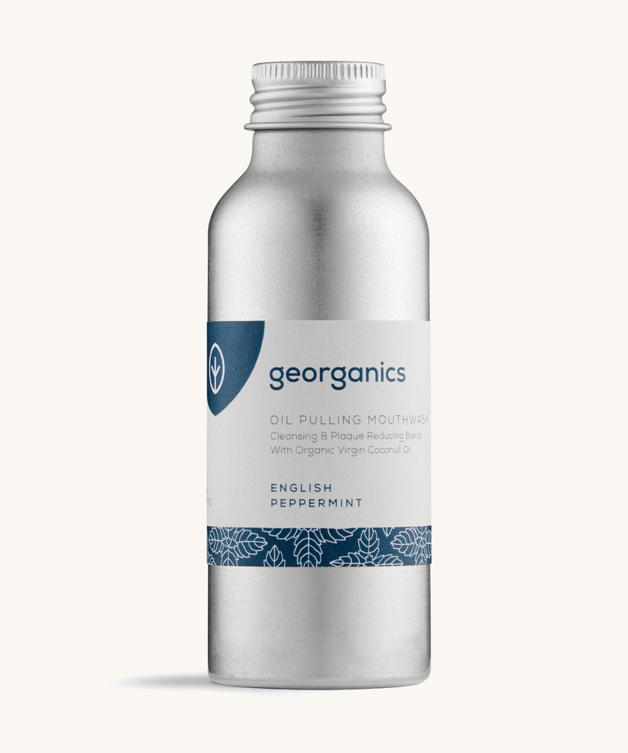 A bottle of the Georganics english peppermint oil pulling mouthwash on a cream background