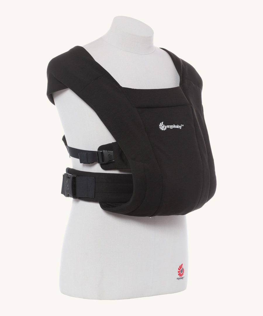 Ergobaby Embrace Soft Knit Newborn Baby Carrier in Pure Black. Side view on a mannequin.