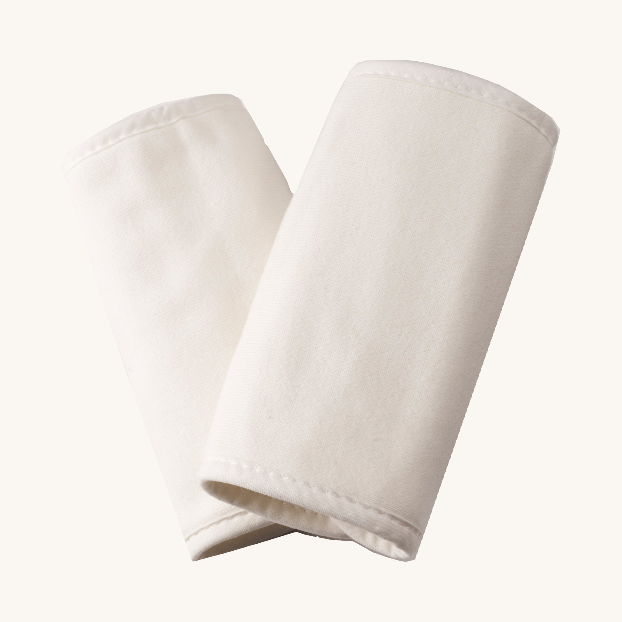 Ergobaby Carrier Cotton Teething/Drool pads in Natural, on a cream background