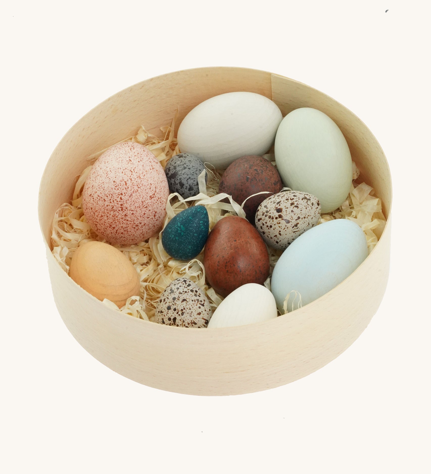 A wooden basket filled with a dozen uniquely painted wooden duck eggs from Erzi.